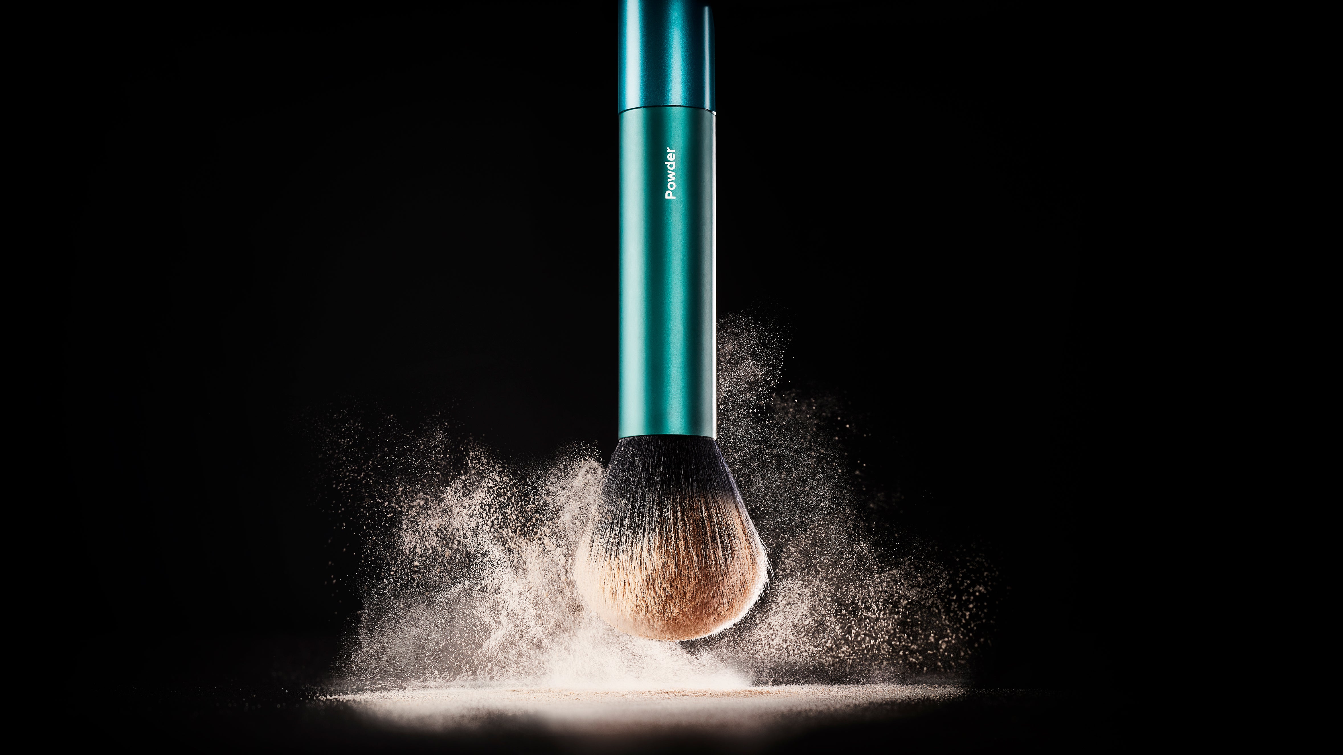 TRUYU Powder Brush, black background with powder blown up on the surface