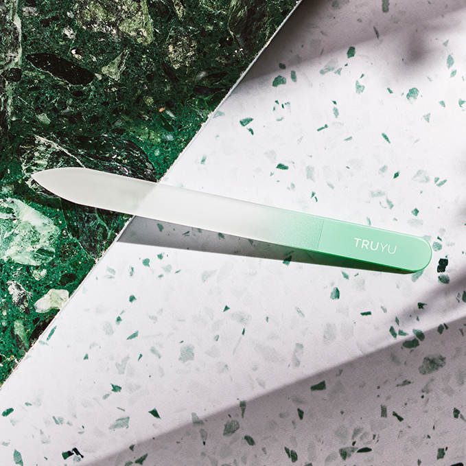 TRUYU Glass Nail File on textured green and white marble background