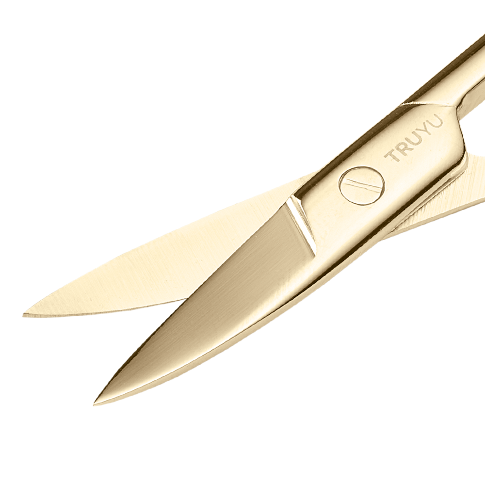 Zoomed in image of TRUYU Gold Curved Nail Scissors. Close-up of gold curved blades half-open.