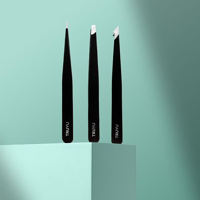Image of Ultimate Tweezer Collection  stood upright on light blue background. Shows all 3 tweezers: Slant, Combo, Point. 