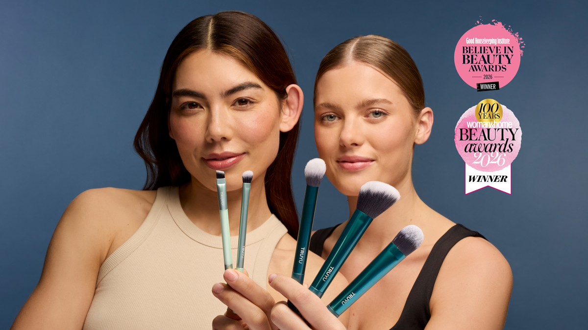 Two models smiling, holding TRUYU Ultimate Brush Collection in front of faces. 'Good Housekeeping Institute Believe In Beauty Awards Winner 2026' logo in top right corner. And 'Woman&Home Beauty Awards 2026 Winner' logo underneath. 