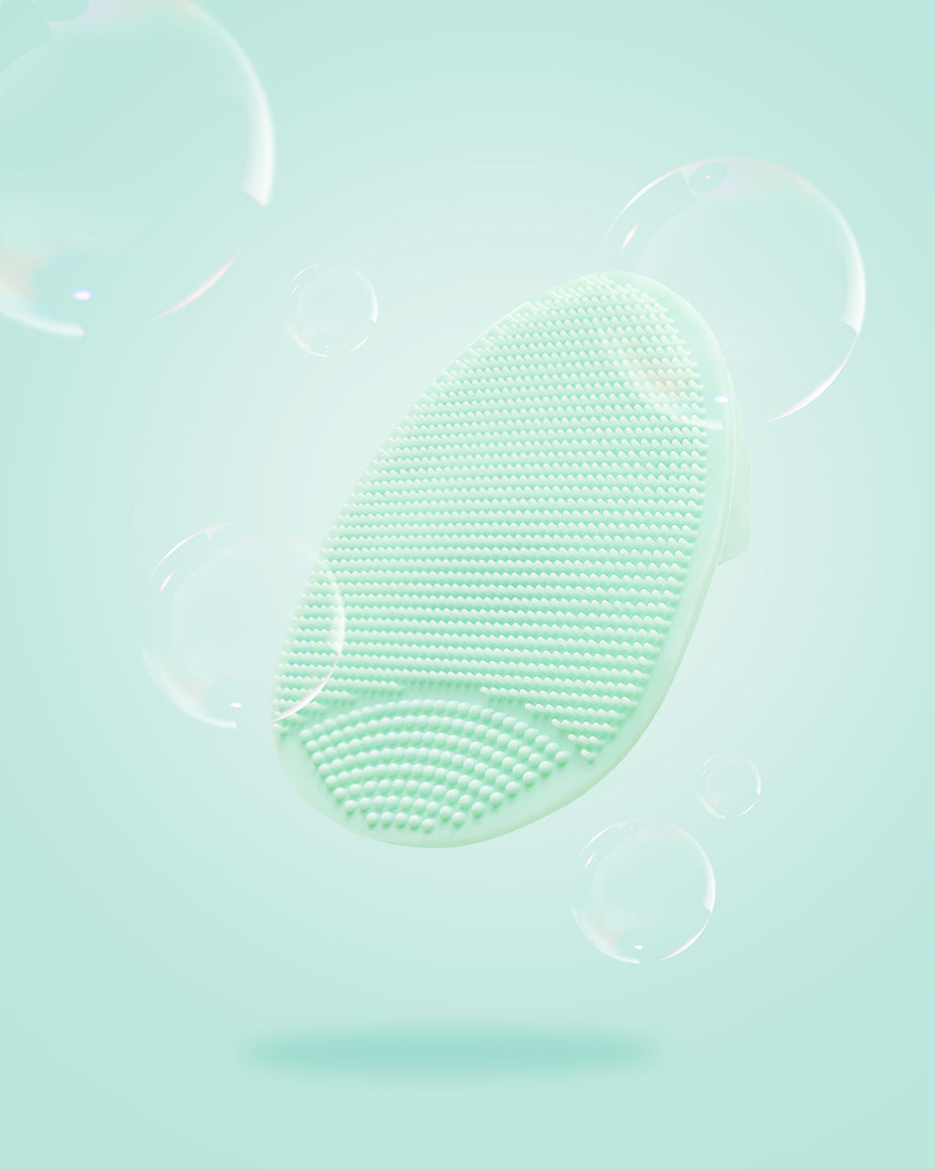 TRUYU mint silicone facial cleansing exfoliator on a light blue background with bubbles