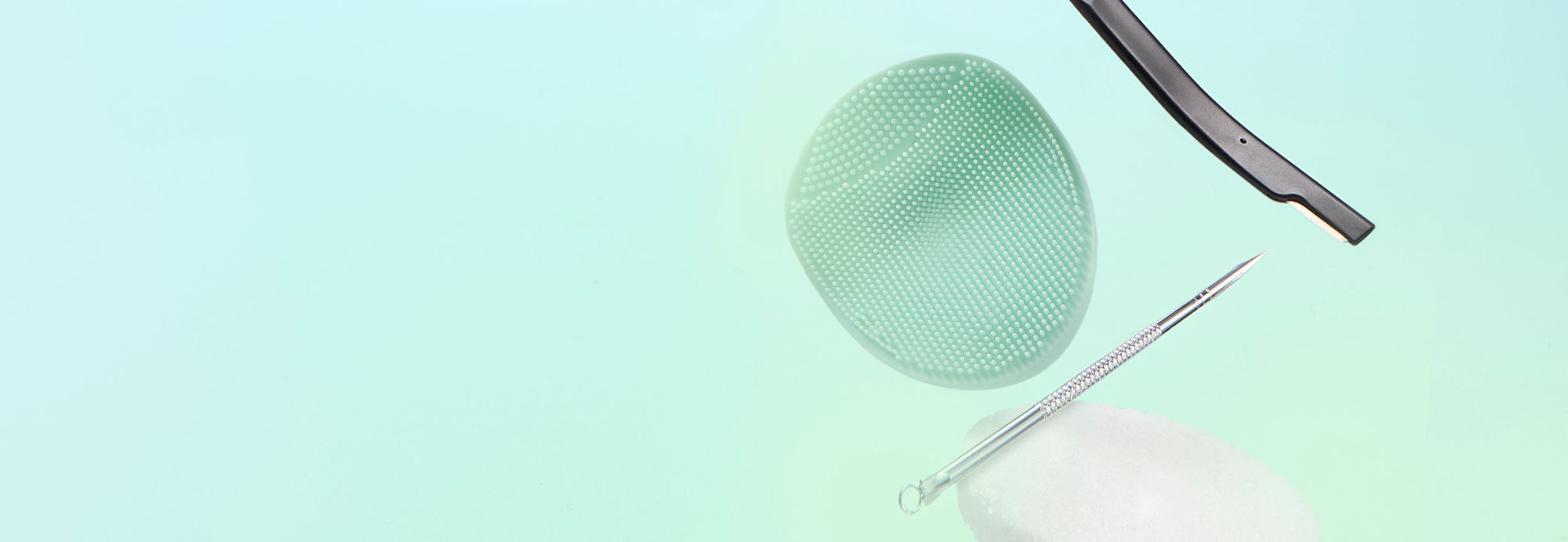 A floating product shot showing a black windshield wiper blade, a light green mesh screen, a thin metal pin, and a white oval component against a soft mint-to-light-blue gradient background.